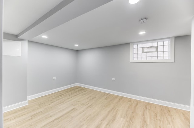 basement with light hardwood / wood-style floors