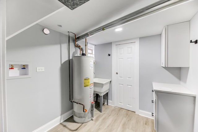 utility room featuring sink and gas water heater