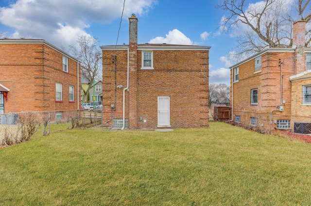 rear view of property featuring central AC unit and a lawn