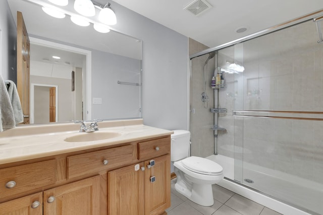 full bath with visible vents, toilet, vanity, a shower stall, and tile patterned floors