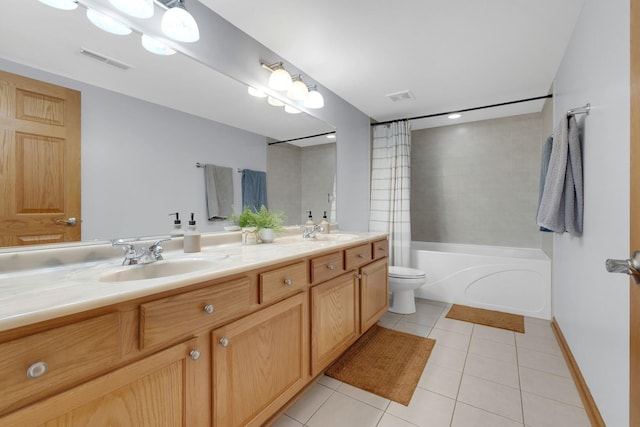 bathroom featuring visible vents, a sink, and tile patterned floors