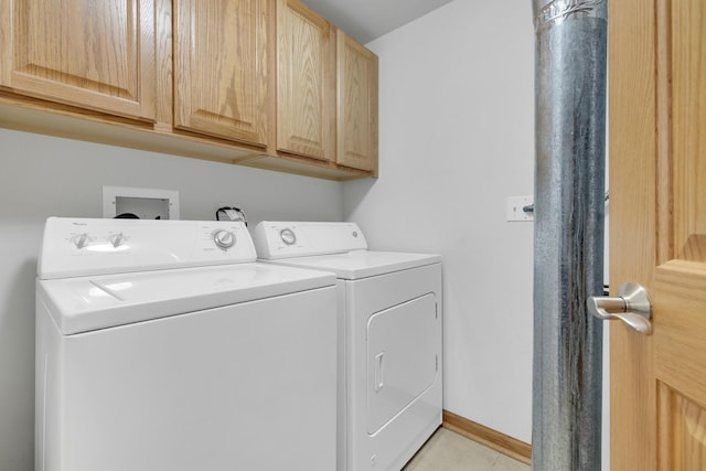 clothes washing area featuring cabinet space, washer and clothes dryer, baseboards, and light tile patterned floors