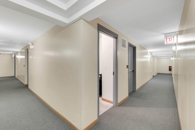 corridor featuring carpet flooring, visible vents, and baseboards