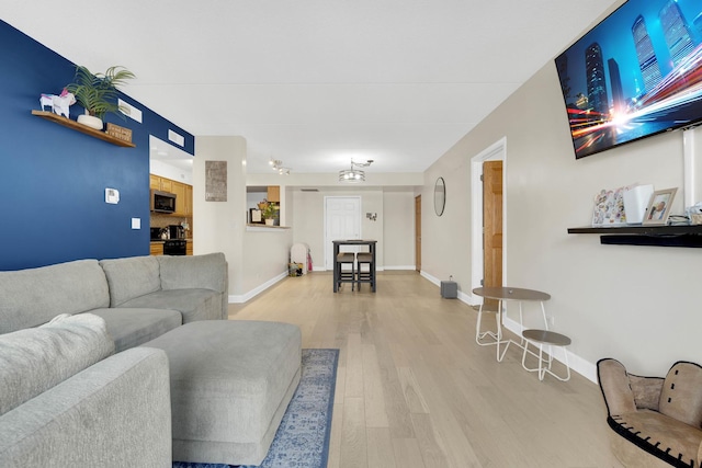 living room with light wood-style floors and baseboards