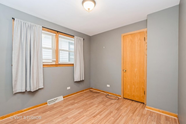 empty room with light hardwood / wood-style floors