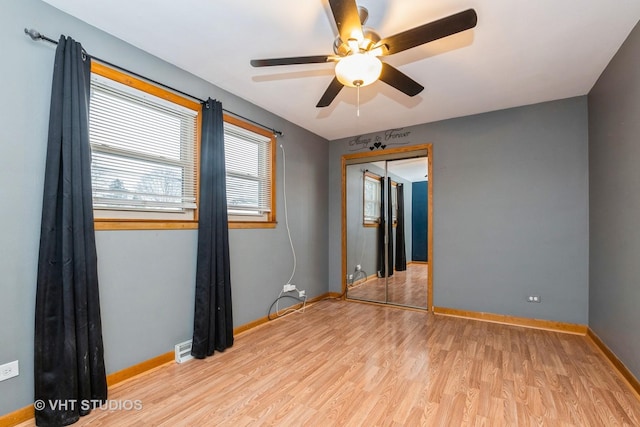 unfurnished room with ceiling fan and light wood-type flooring