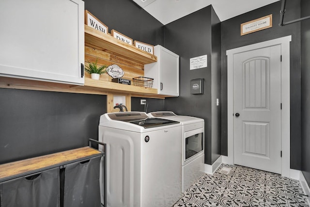 clothes washing area with cabinets, separate washer and dryer, and light tile patterned flooring