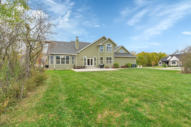 rear view of house featuring a patio area and a lawn