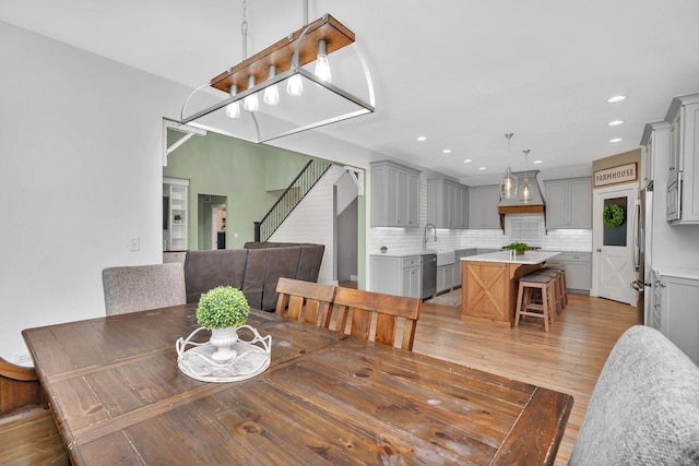 dining area with sink and dark wood-type flooring