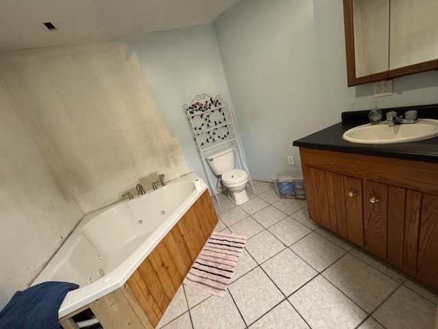 bathroom featuring tile patterned floors, toilet, a bath, and vanity