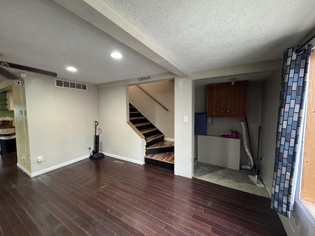 interior space with dark hardwood / wood-style flooring and a textured ceiling