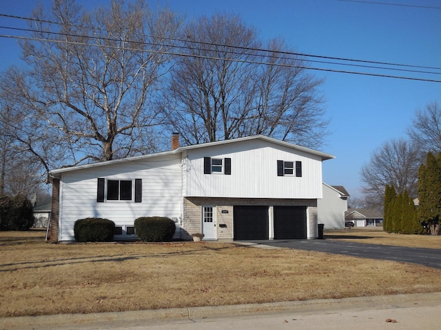 view of side of property featuring a garage and a yard