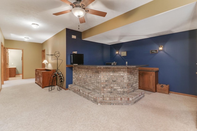 bar featuring a dry bar, baseboards, and light colored carpet