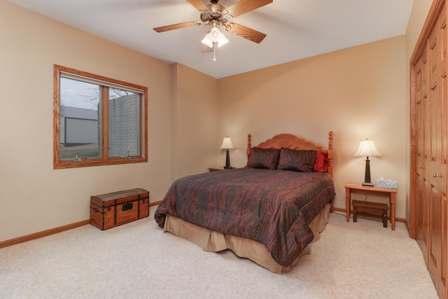 bedroom featuring ceiling fan, a closet, carpet, and baseboards