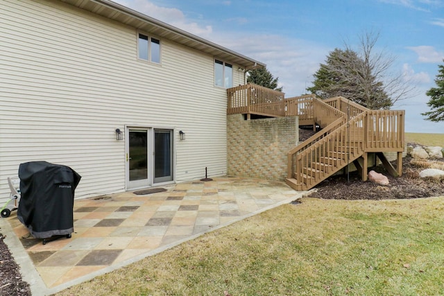 back of house with stairs, a patio, a yard, and a wooden deck