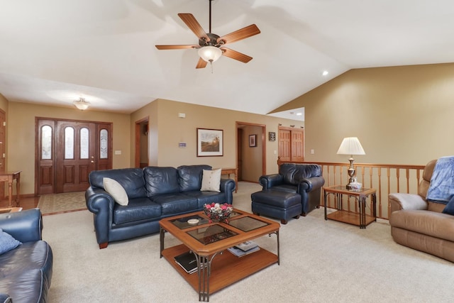 living room featuring light carpet, ceiling fan, vaulted ceiling, and a wainscoted wall