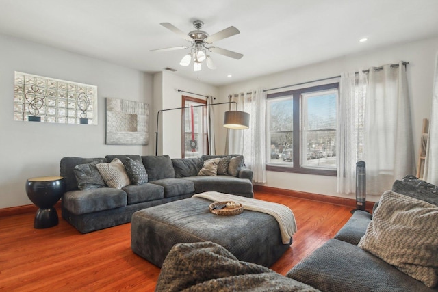 living area with recessed lighting, wood finished floors, visible vents, a ceiling fan, and baseboards