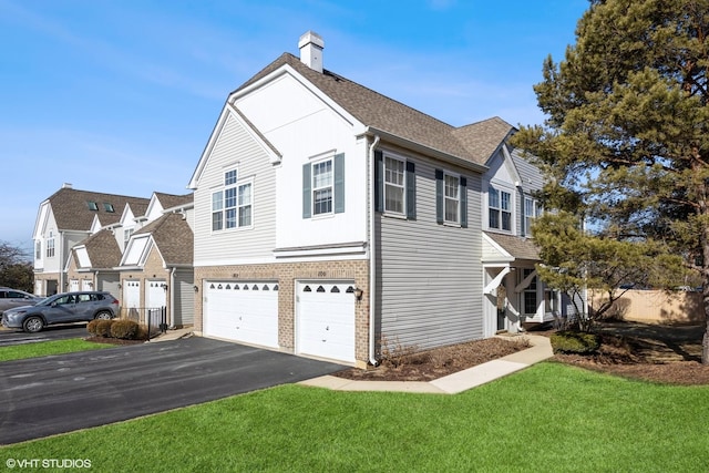 view of side of property with a yard and a garage