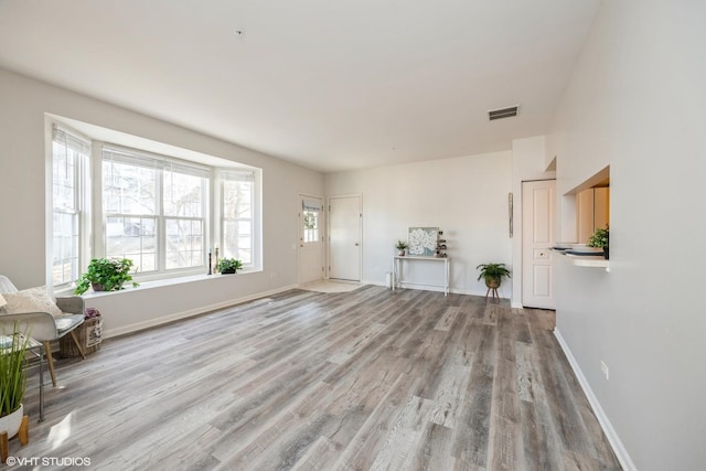 unfurnished living room with light hardwood / wood-style flooring