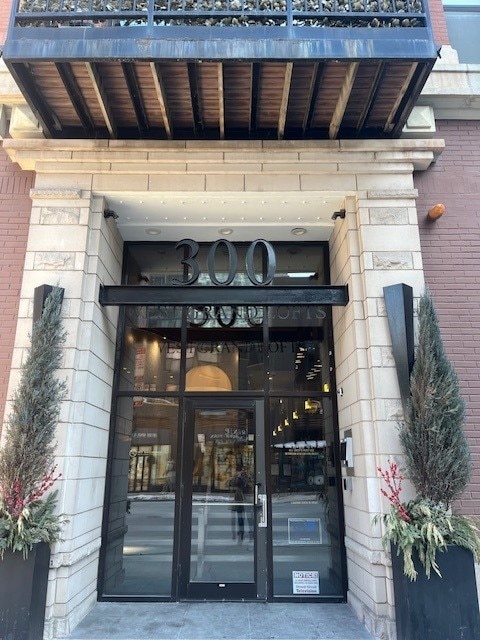 property entrance featuring brick siding