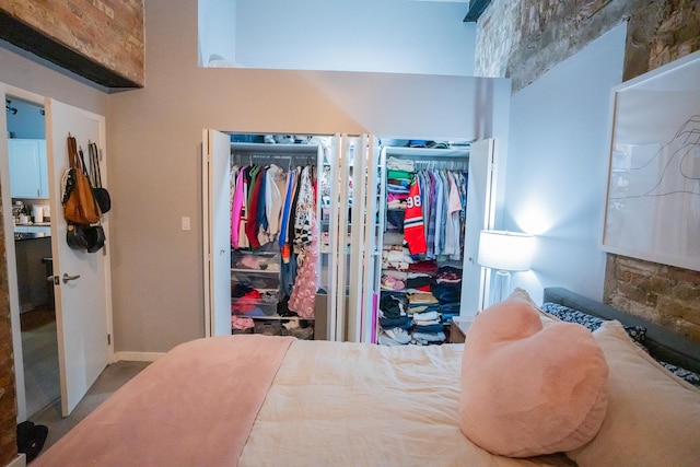 bedroom featuring a towering ceiling and two closets