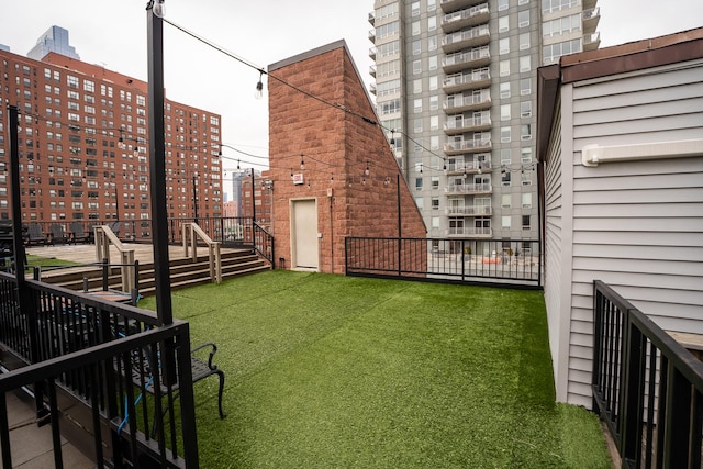 view of yard featuring fence and a city view