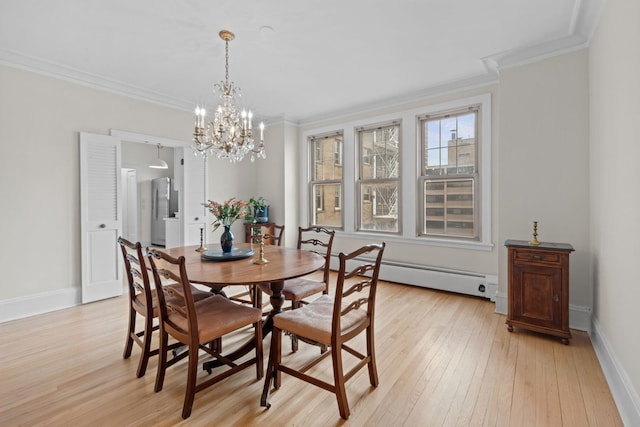 dining room featuring ornamental molding, a baseboard heating unit, an inviting chandelier, and light hardwood / wood-style flooring