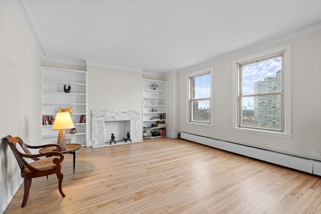 living area with crown molding, a baseboard radiator, light hardwood / wood-style flooring, and built in features