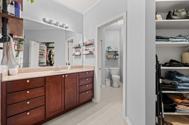 bathroom with vanity, tile patterned flooring, and toilet