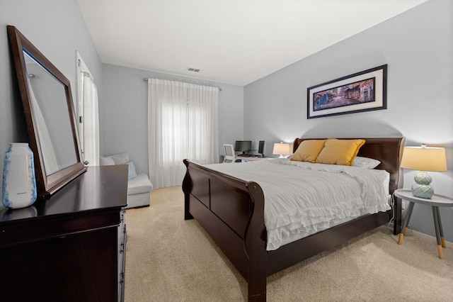 bedroom featuring light carpet