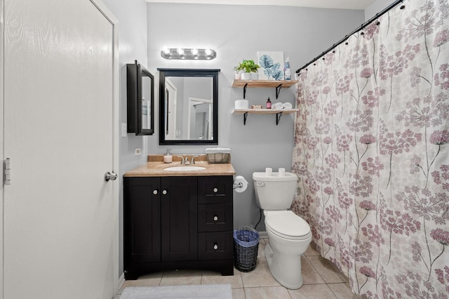 bathroom featuring tile patterned flooring, vanity, and toilet