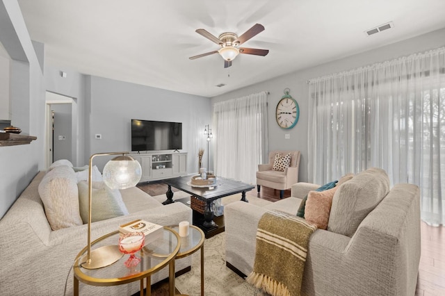 living room featuring ceiling fan and light hardwood / wood-style floors