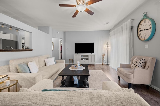 living room with ceiling fan and hardwood / wood-style floors