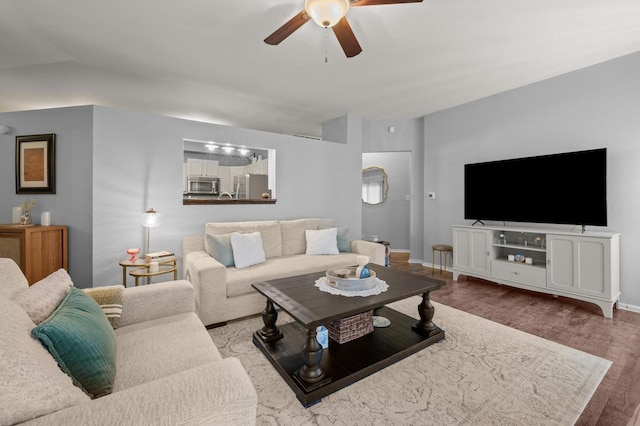 living room featuring hardwood / wood-style floors and ceiling fan