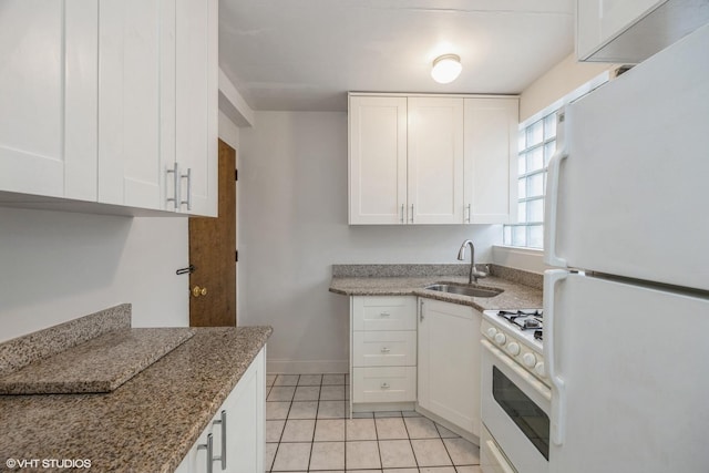 kitchen with white cabinetry, white appliances, light tile patterned flooring, and sink