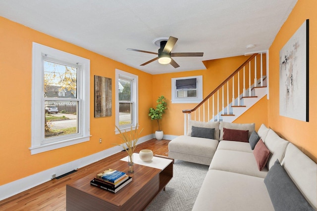 living room featuring light hardwood / wood-style floors and ceiling fan