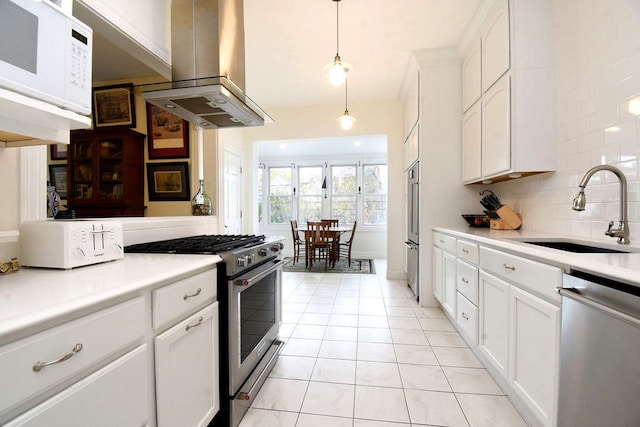 kitchen with sink, white cabinetry, appliances with stainless steel finishes, pendant lighting, and island exhaust hood