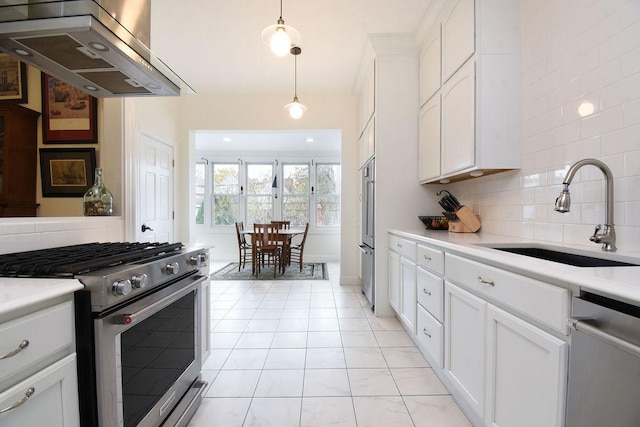 kitchen featuring pendant lighting, sink, white cabinets, island exhaust hood, and stainless steel appliances