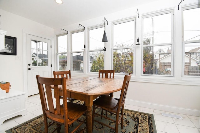 tiled dining area featuring a wealth of natural light