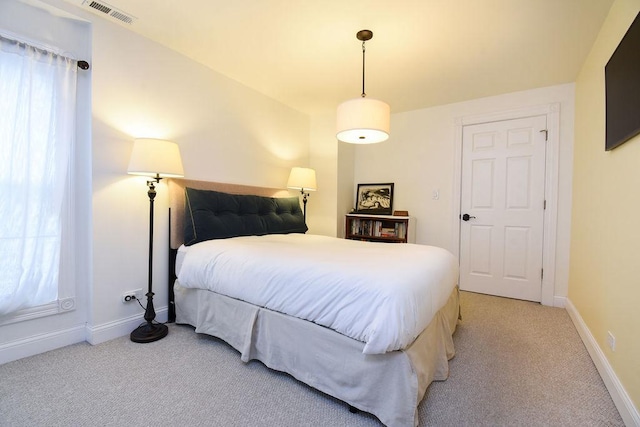 bedroom featuring light colored carpet