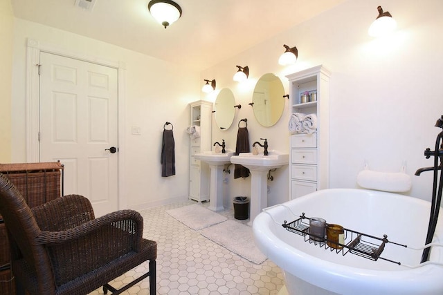 bathroom with tile patterned floors and a bathtub