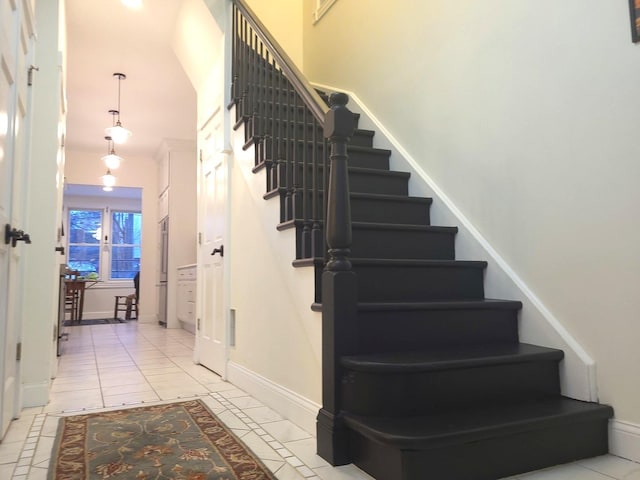 stairway with tile patterned floors