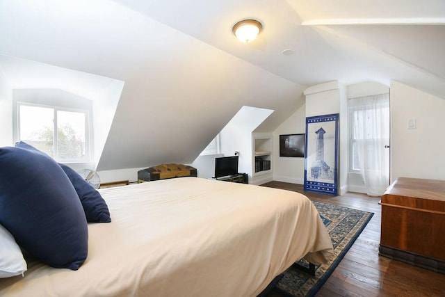 bedroom with multiple windows, vaulted ceiling, and dark hardwood / wood-style floors