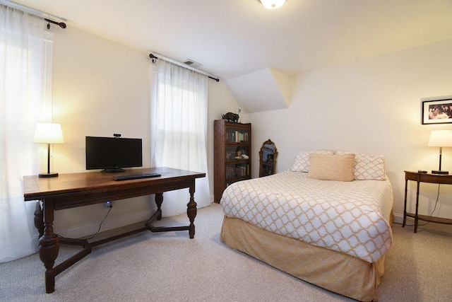 carpeted bedroom with lofted ceiling