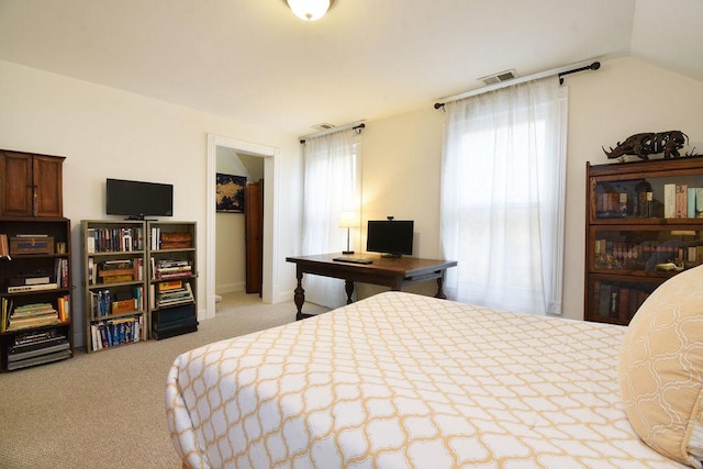 bedroom featuring lofted ceiling and light colored carpet