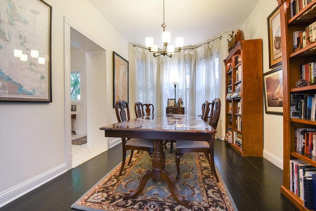 dining space featuring a chandelier and dark hardwood / wood-style flooring