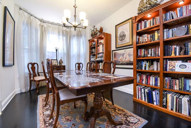 dining room with an inviting chandelier and dark hardwood / wood-style flooring