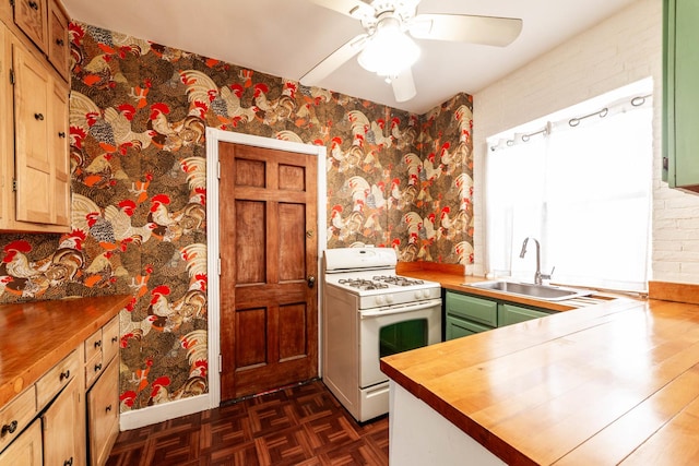 kitchen with wood counters, dark parquet flooring, sink, white range with gas stovetop, and ceiling fan