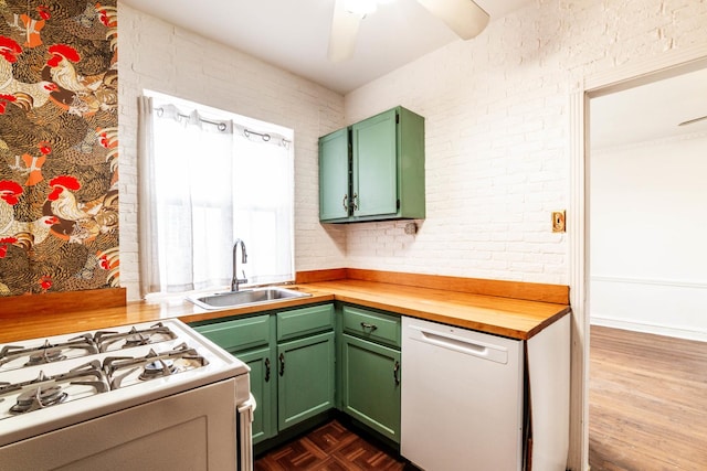 kitchen with butcher block countertops, sink, white appliances, green cabinetry, and ceiling fan