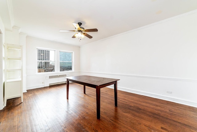 unfurnished office with crown molding, ceiling fan, radiator heating unit, and dark hardwood / wood-style flooring